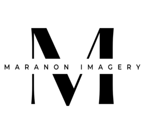 Professional Photographer Large black letter M with the words MARANON IMAGERY in capital letters across the center, representing expert headshots and pet photography, all set on a crisp white background. www.maranonimagery.com