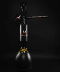 Professional Photographer A freestanding black boxing trainer with padded sections labeled Hit N Move, perfect for photographers capturing action shots, featuring a round base, vertical punching post, horizontal rotating arm, and a padded target on top against a dark background. www.maranonimagery.com