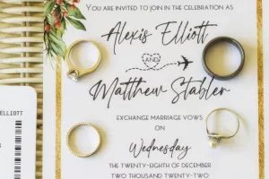 Professional Photographer A wedding invitation for Alexis Elliott and Matthew Stabler is decorated with four rings, greenery, and elegant portraits. The invitation details the ceremony to exchange marriage vows on Wednesday, December 28, 2022. www.maranonimagery.com